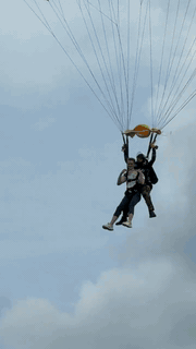 Leonid landing under a parachute after a tandem skydive